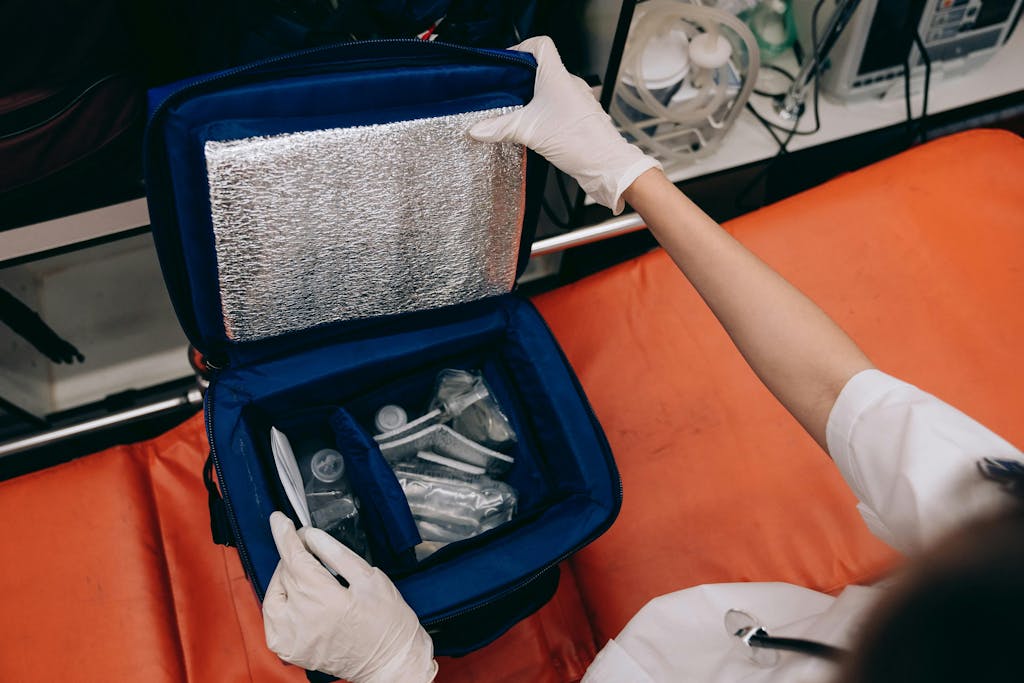 Paramedic utilizing an intubation kit with medical tools in an emergency setting.